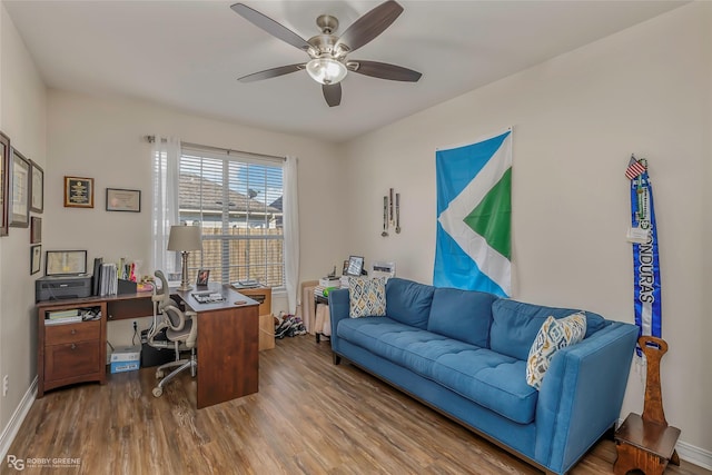 home office featuring ceiling fan, baseboards, and wood finished floors