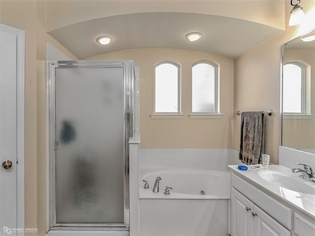 full bath featuring vanity, a jetted tub, and a stall shower