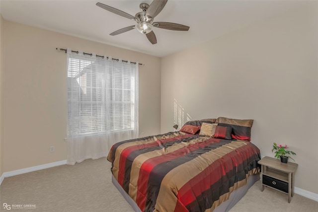 carpeted bedroom featuring baseboards and ceiling fan