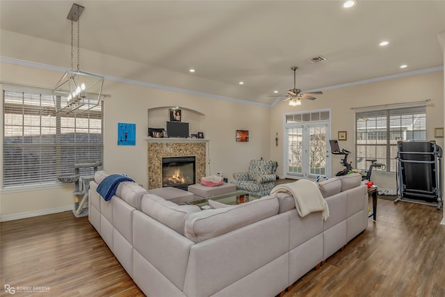 living room featuring visible vents, crown molding, and wood finished floors