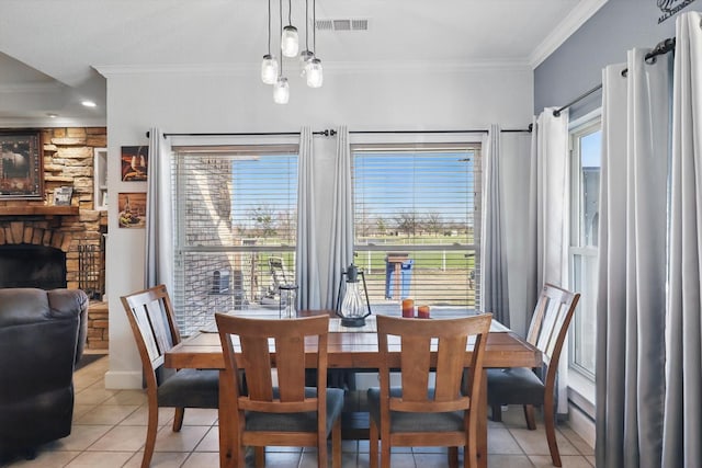 dining area with light tile patterned floors, visible vents, plenty of natural light, and crown molding