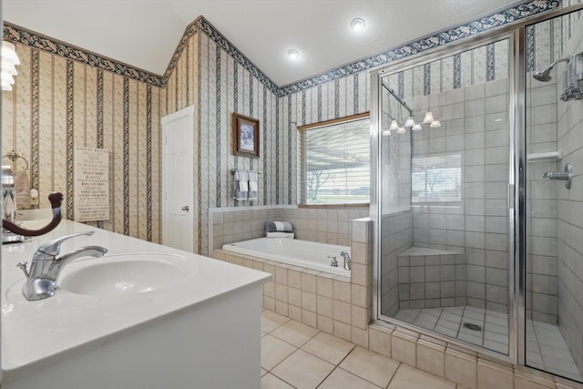 full bath with wallpapered walls, a shower stall, a bath, and a sink