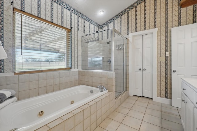 bathroom featuring vanity, a tub with jets, wallpapered walls, a stall shower, and tile patterned floors