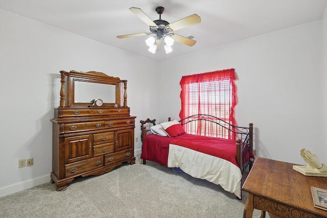 bedroom with baseboards, carpet, and a ceiling fan