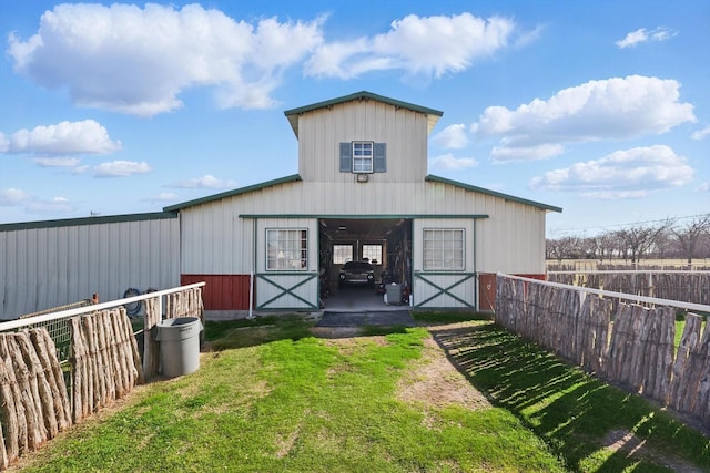 view of outbuilding with an outbuilding, an exterior structure, and fence