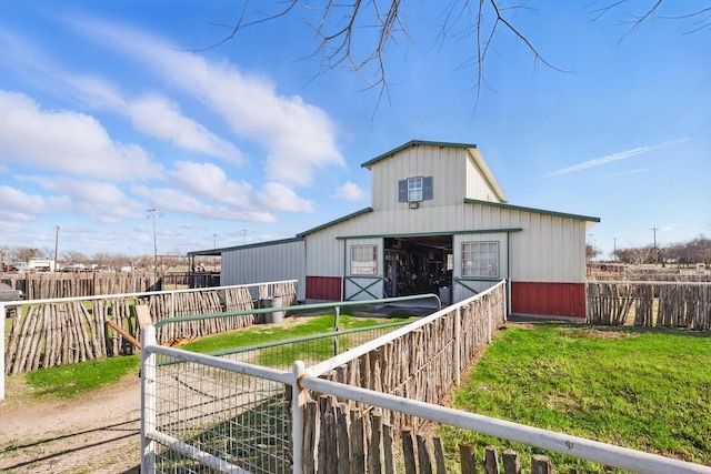 exterior space featuring an outbuilding, driveway, a detached garage, and an exterior structure