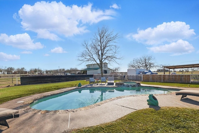 view of swimming pool with a lawn, a patio, a pool with connected hot tub, and a fenced backyard