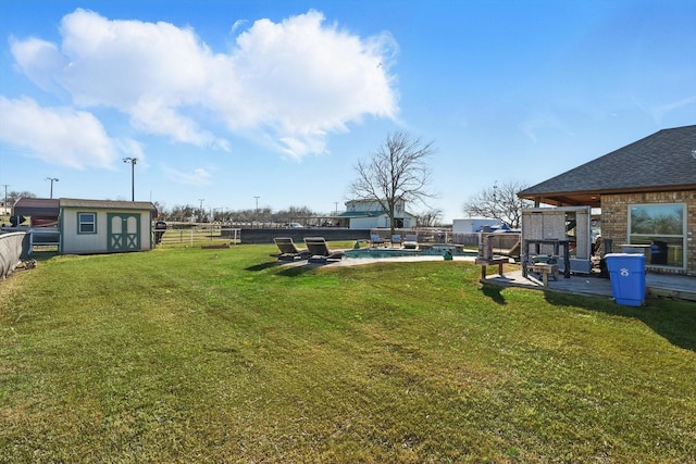 view of yard featuring a fenced backyard, a fenced in pool, a storage shed, and an outdoor structure