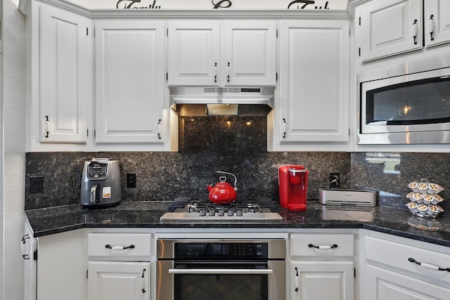 kitchen featuring under cabinet range hood, white cabinets, appliances with stainless steel finishes, and tasteful backsplash