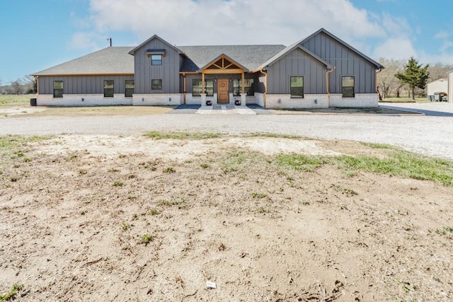 view of front of house with board and batten siding and a shingled roof