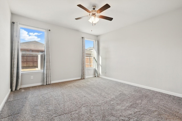 spare room featuring ceiling fan, baseboards, and carpet floors