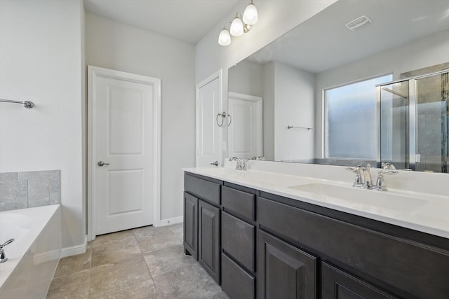 full bathroom featuring a bath, a shower stall, double vanity, and a sink