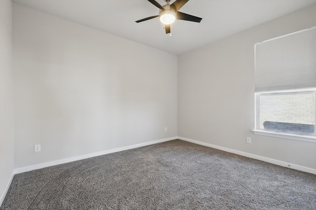 spare room with a ceiling fan, carpet, and baseboards