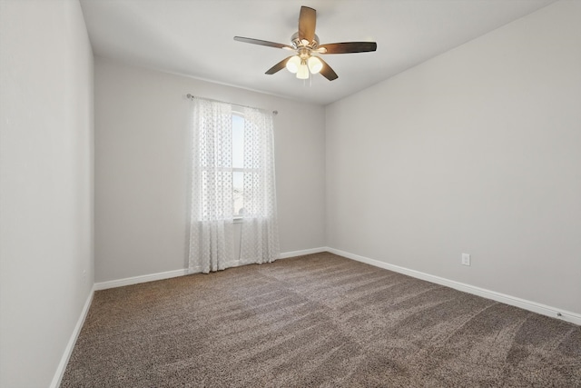 carpeted empty room featuring baseboards and ceiling fan