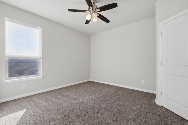 carpeted spare room with baseboards and ceiling fan