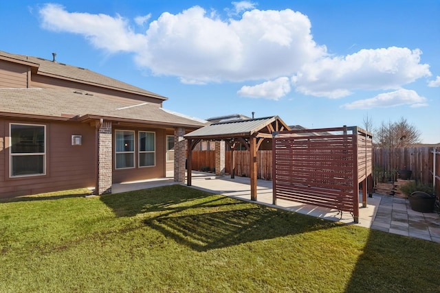 view of yard featuring a gazebo, a patio area, and a fenced backyard