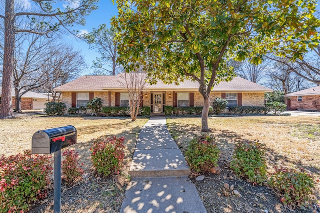 single story home with brick siding