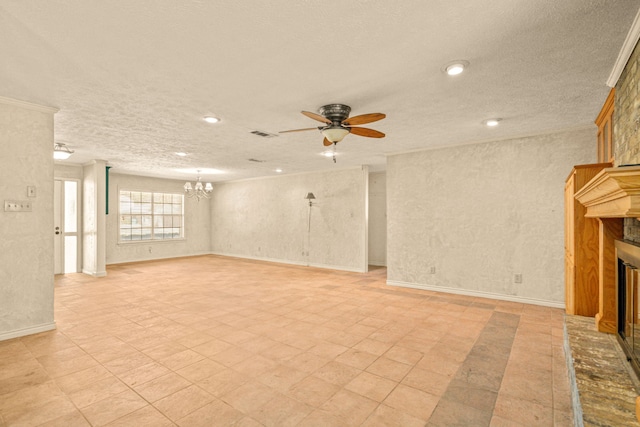 unfurnished living room with baseboards, visible vents, a fireplace with raised hearth, a textured ceiling, and ceiling fan with notable chandelier