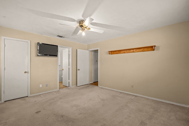 unfurnished bedroom with a ceiling fan, visible vents, carpet floors, and connected bathroom