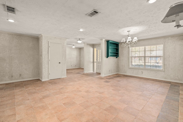 unfurnished room featuring a notable chandelier, baseboards, visible vents, and a textured ceiling