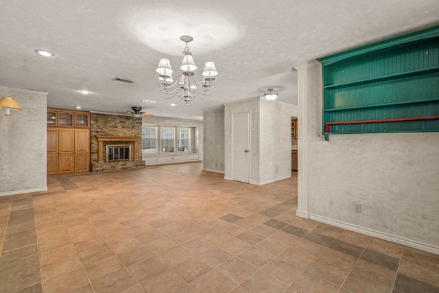 unfurnished living room with a brick fireplace, ceiling fan with notable chandelier, visible vents, and a textured ceiling