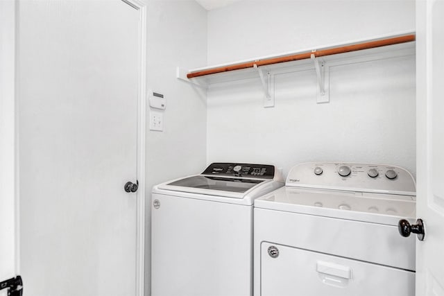 washroom with independent washer and dryer and laundry area