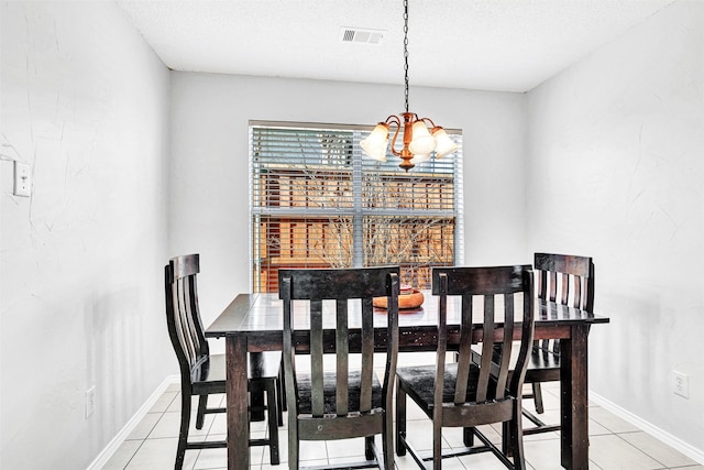 dining room with visible vents, baseboards, an inviting chandelier, tile patterned floors, and a textured ceiling