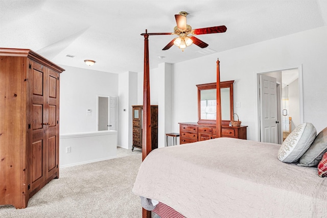 bedroom featuring a ceiling fan, visible vents, and light carpet