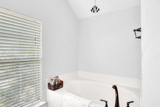 full bathroom featuring a garden tub and vaulted ceiling