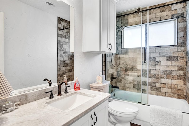 full bathroom featuring visible vents, toilet, a textured wall, enclosed tub / shower combo, and a textured ceiling