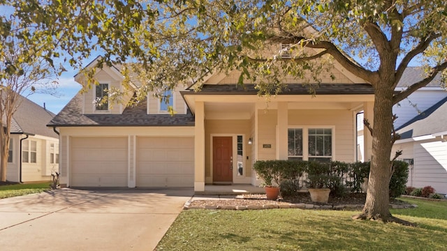 view of front of property with a front lawn, an attached garage, driveway, and roof with shingles