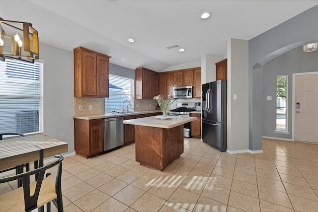 kitchen with visible vents, a sink, appliances with stainless steel finishes, light tile patterned flooring, and light countertops