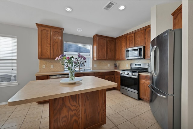 kitchen with light countertops, light tile patterned floors, visible vents, and appliances with stainless steel finishes