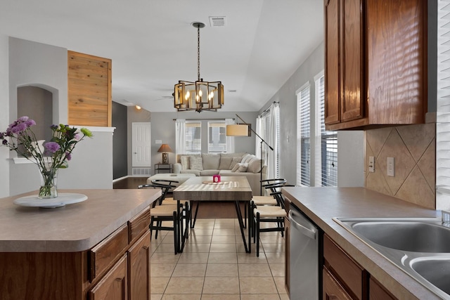 kitchen featuring visible vents, a sink, tasteful backsplash, stainless steel dishwasher, and light tile patterned floors