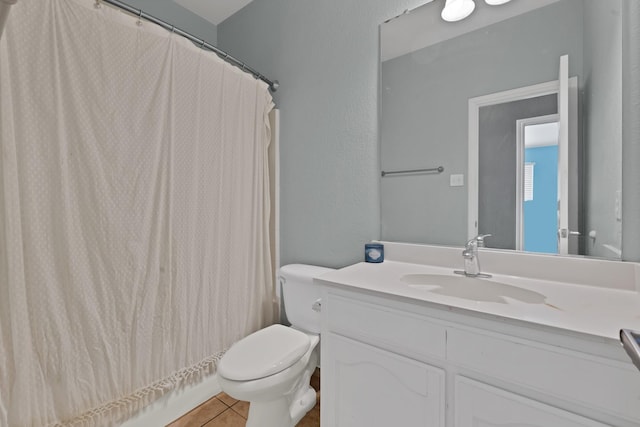 full bathroom featuring curtained shower, toilet, vanity, and tile patterned flooring