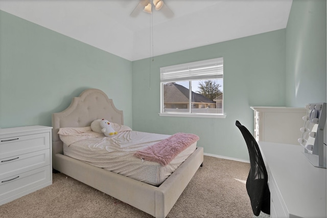 bedroom featuring light colored carpet, baseboards, and ceiling fan