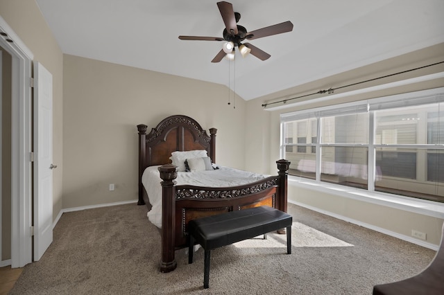 carpeted bedroom with lofted ceiling, a ceiling fan, and baseboards