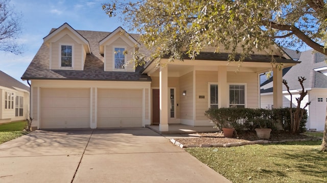 view of front of property with a garage, concrete driveway, and roof with shingles