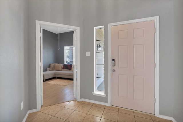 entryway featuring light tile patterned floors and baseboards