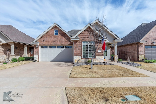 craftsman house with a garage, stone siding, brick siding, and concrete driveway