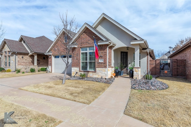 view of front facade with a garage, a gate, brick siding, and driveway