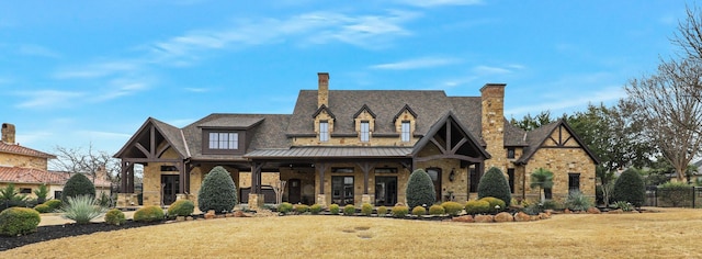 view of front of house featuring metal roof, a front lawn, and a standing seam roof