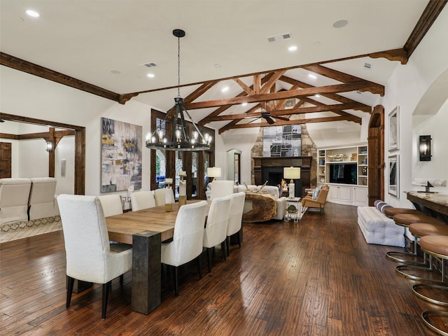 dining room featuring visible vents, a large fireplace, and dark wood-style floors