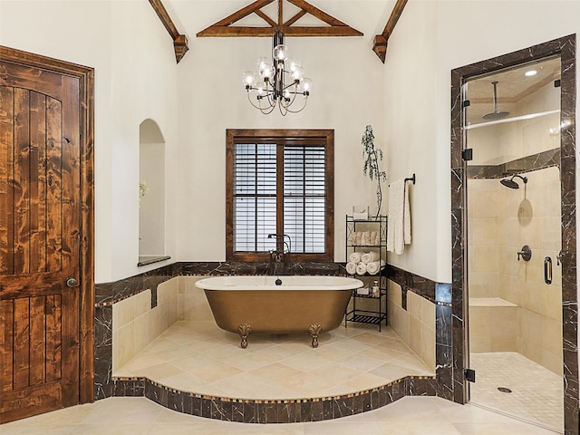 bathroom featuring tile patterned floors, a stall shower, tile walls, wainscoting, and a freestanding bath