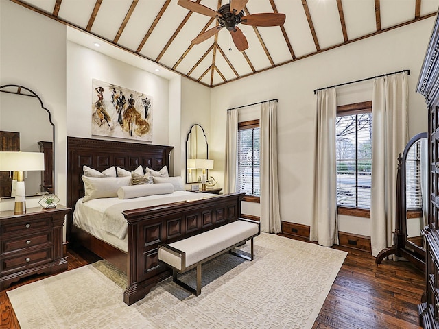 bedroom featuring baseboards, multiple windows, and dark wood-type flooring