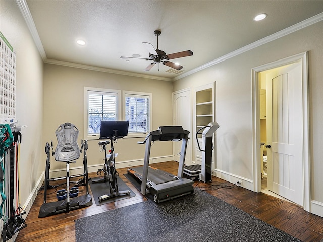 workout area featuring ceiling fan, wood finished floors, baseboards, and ornamental molding