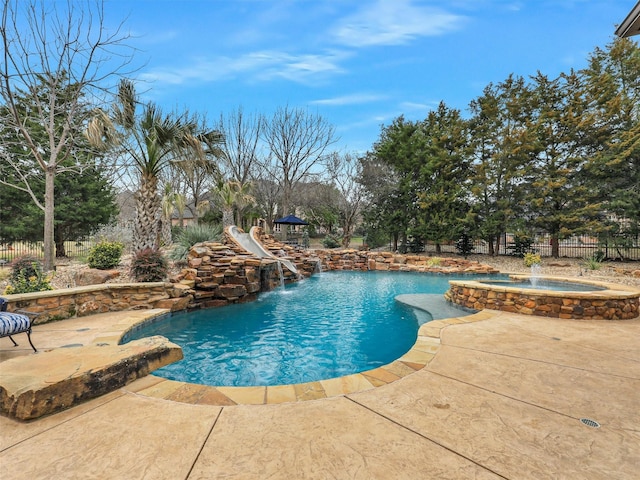 view of pool featuring a fenced in pool, fence, an in ground hot tub, and a patio area