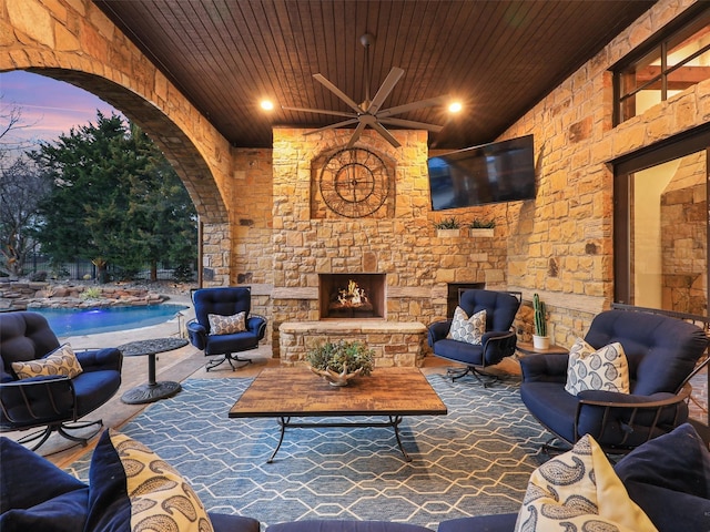 view of patio featuring an outdoor living space with a fireplace