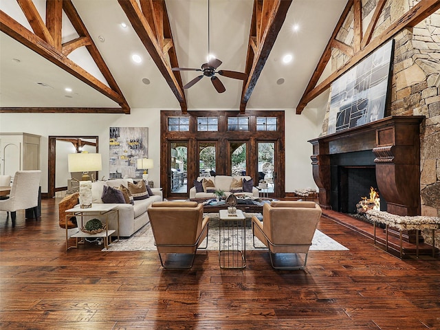 living area featuring beamed ceiling, a fireplace, high vaulted ceiling, and hardwood / wood-style floors