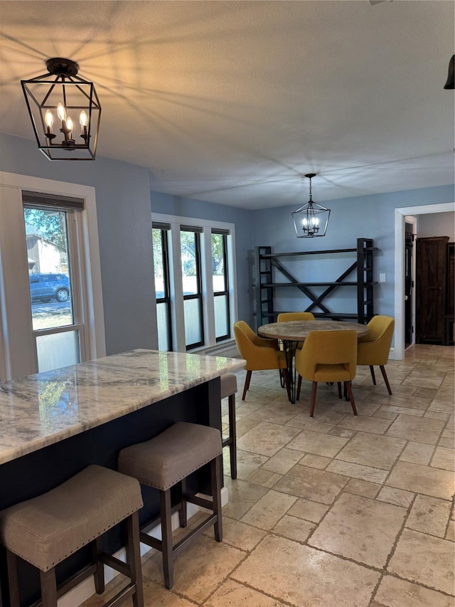 3200 Dover Dr, Plano, TX 75075 - dining room featuring a chandelier, stone tile flooring, and healthy amount of natural light
